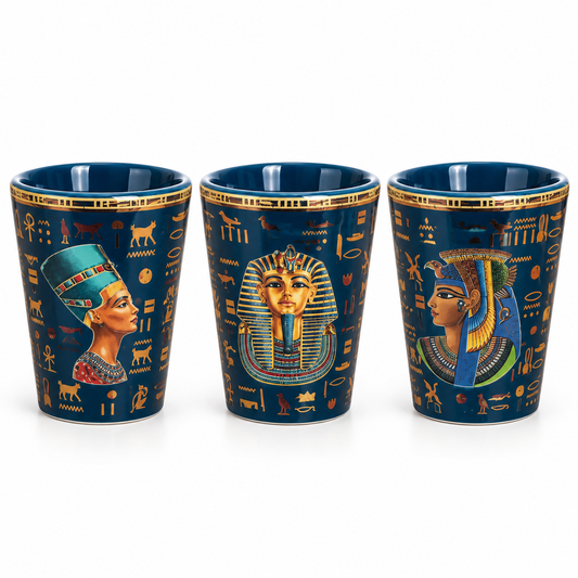 Three dark blue ceramic shot glasses with gold Egyptian hieroglyphics and colorful pharaoh illustrations, shown on a white background.