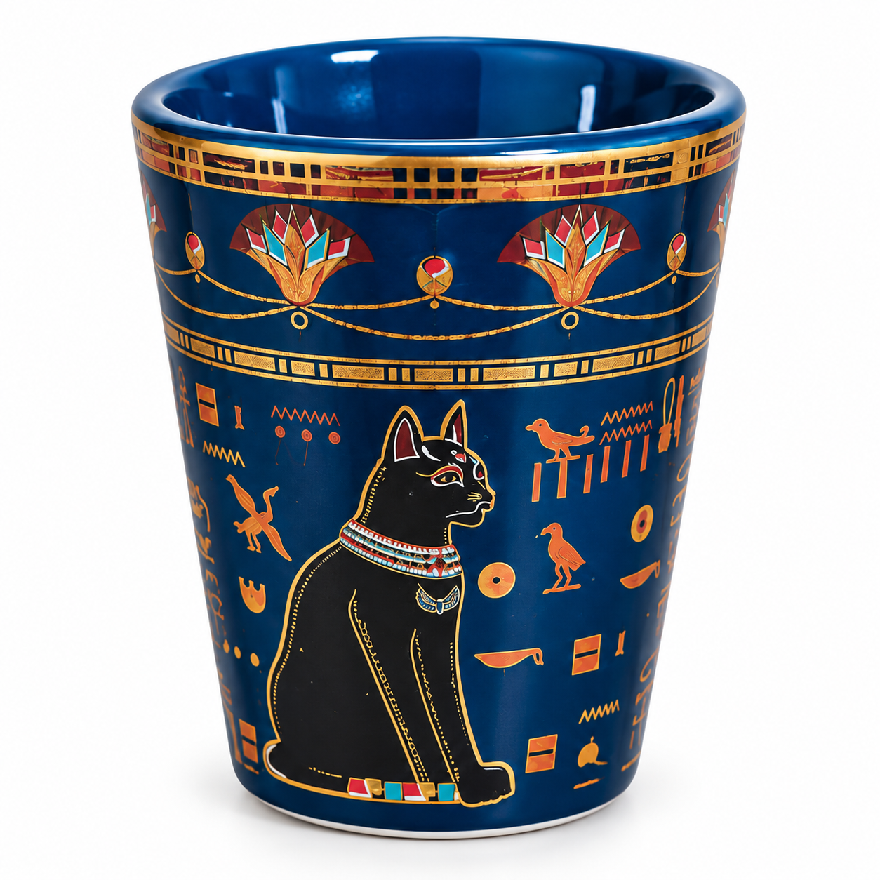 A dark blue ceramic cup decorated with gold Egyptian-style hieroglyphs, a black cat illustration, and colorful accents, shown on a white background.