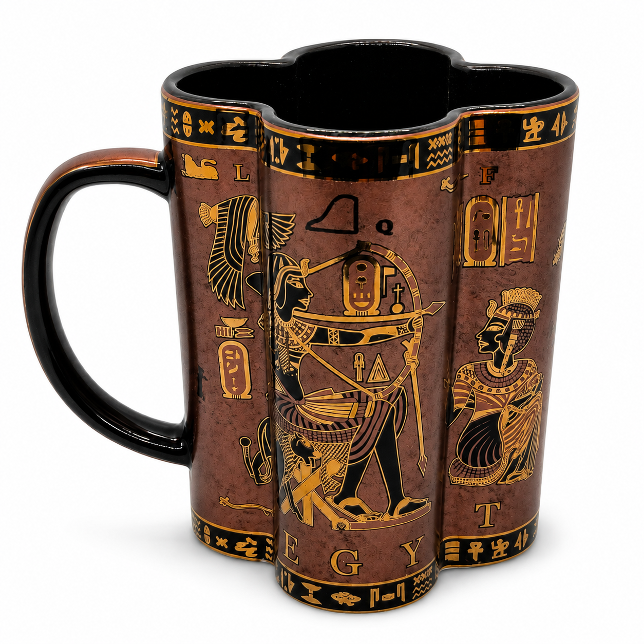 An Egyptian-themed ceramic mug with a dark reddish-brown glaze, black handle and interior, and gold hieroglyphic illustrations depicting figures and symbols.