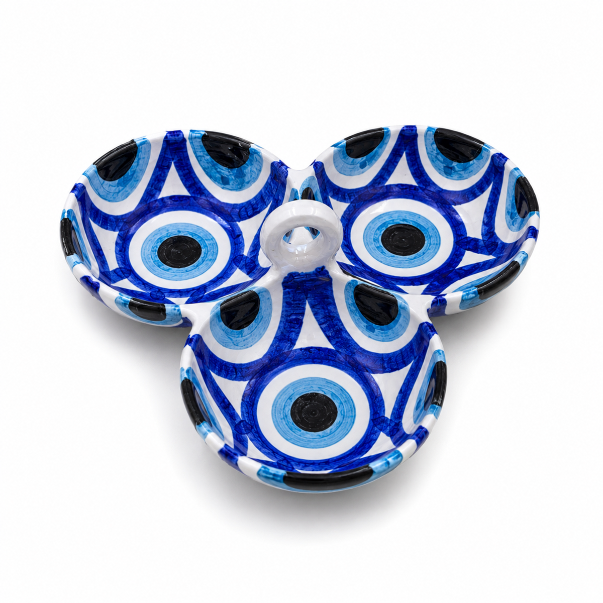 Three small shallow bowls arranged in a cluster, decorated with a blue, white, and black evil eye pattern, on a white background.