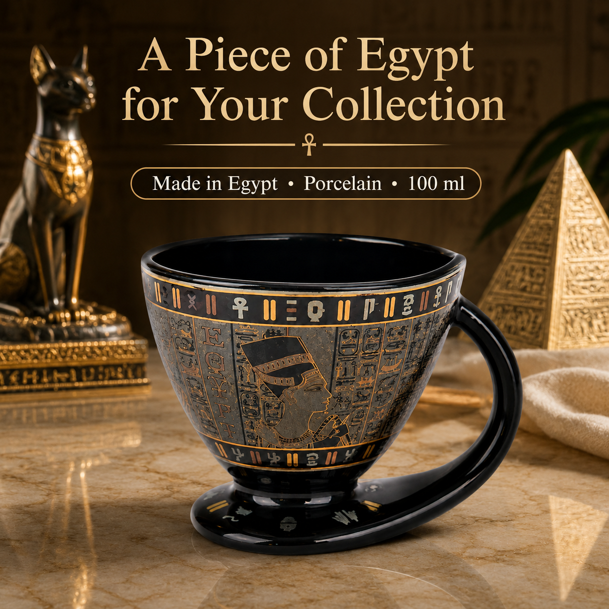 A 100 ml black porcelain cup with gold Egyptian hieroglyphics and cartouches, displayed on a marble surface with an Ankh and sphinx background. Text overlay at the top reads 'A Piece of Egypt for Your Collection'.