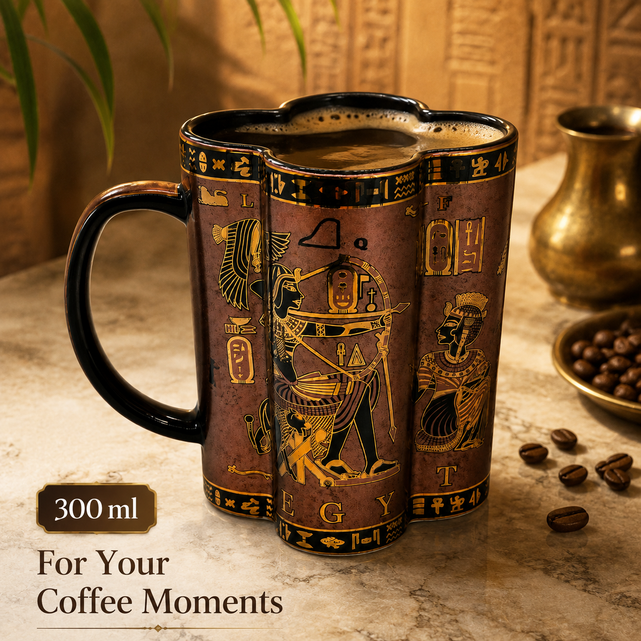 A 300 ml Egyptian-themed ceramic coffee mug with a handle, featuring gold hieroglyphic designs on a dark brown and bronze background. The mug is filled with coffee and sits on a marble surface with coffee beans and a brass pot in the background.