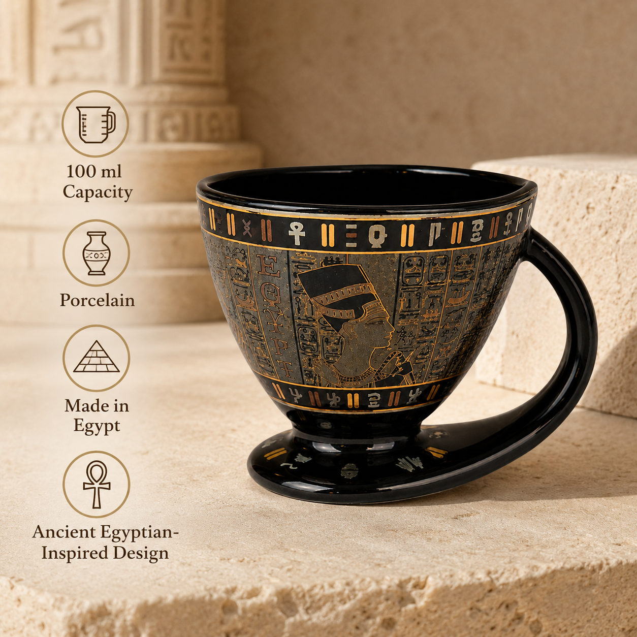 Black and gold porcelain cup with an ancient Egyptian-inspired hieroglyphic design, set on a beige stone pedestal with feature callouts on the left.