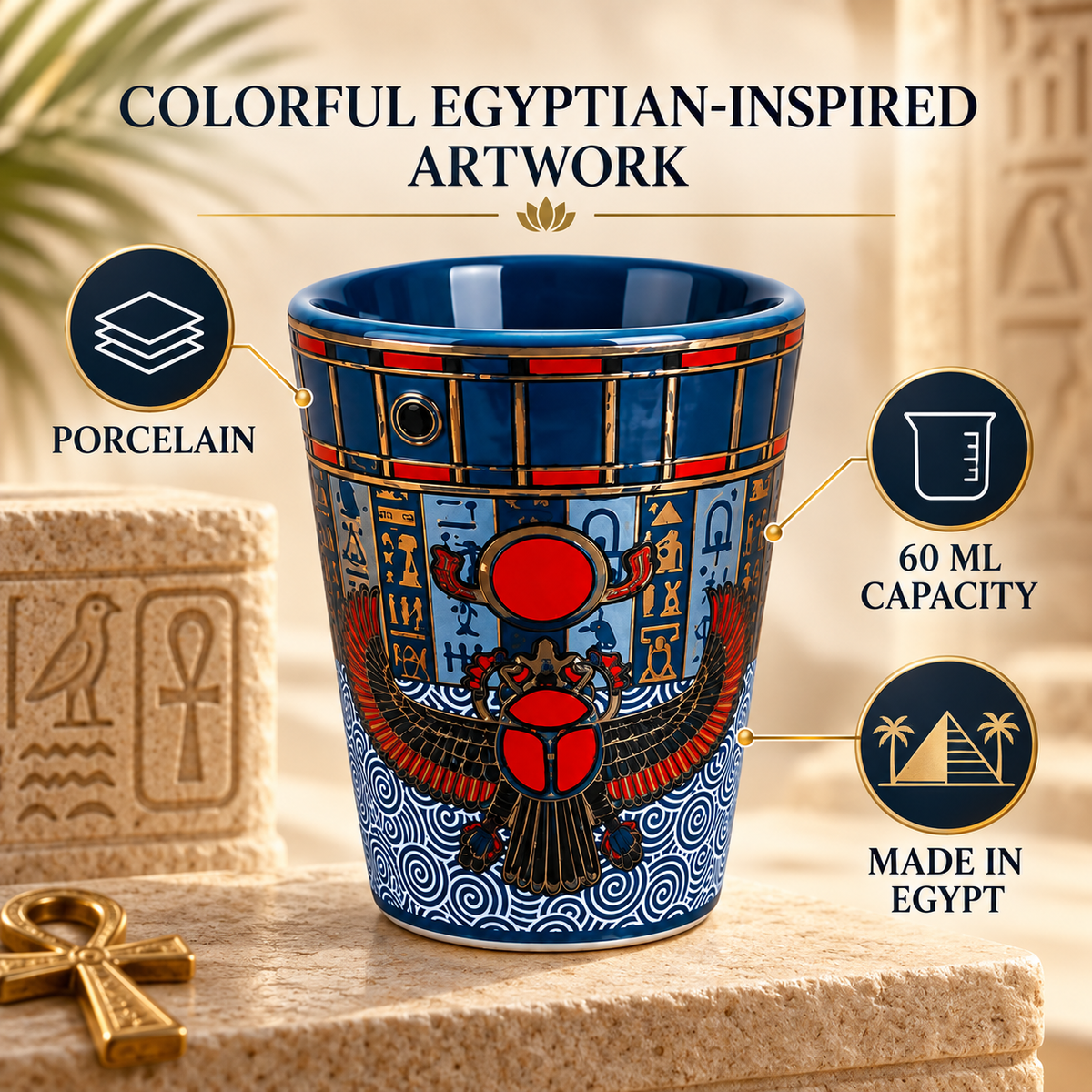 A decorative ceramic cup with an Egyptian-inspired design, featuring a blue and gold hieroglyphic pattern and a red scarab beetle motif. The cup is displayed on a stone pedestal with text overlays highlighting its features: 'COLORFUL EGYPTIAN-INSPIRED ARTWORK', 'PORCELAIN', '60 ML CAPACITY', and 'MADE IN EGYPT'.
