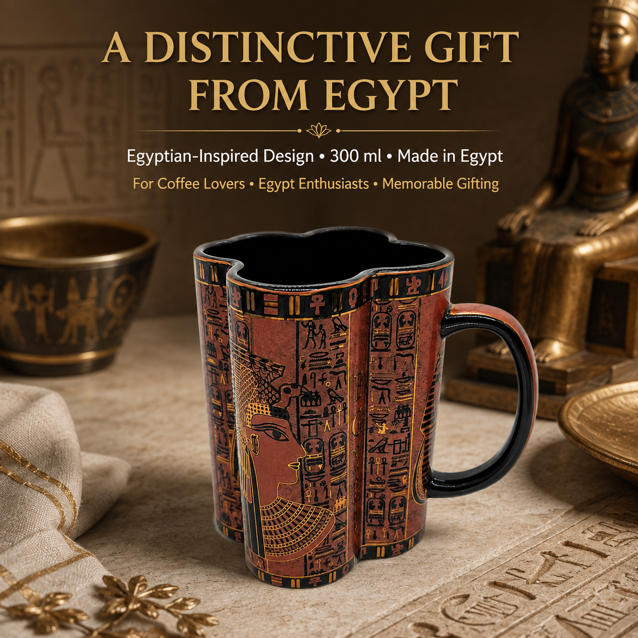 A 300 ml ceramic mug with an Egyptian-inspired design, featuring a reddish-brown papyrus background with black hieroglyphs and gold-colored details. The mug is set on a textured stone surface with ancient Egyptian props, including a gold statue and a small bronze vessel, under the text 'A DISTINCTIVE GIFT FROM EGYPT'.