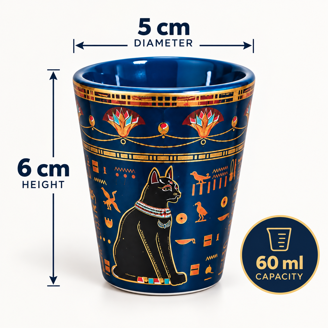 A navy blue ceramic cup with gold and black Egyptian-themed illustrations, including a cat and hieroglyphs, shown with dimension labels indicating 5 cm diameter, 6 cm height, and 60 ml capacity.