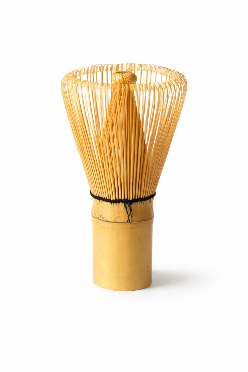 Bamboo whisk used for making matcha tea on a white background