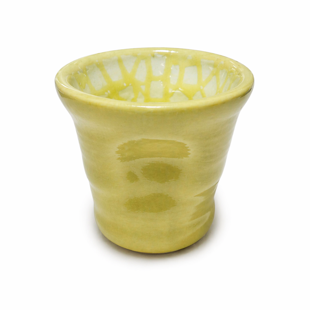 Yellow ceramic cup with textured surface on a white background