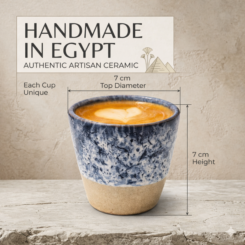 Ceramic cup with blue and beige design, filled with a warm beverage, on a wooden surface with 'Handmade in Egypt' label.