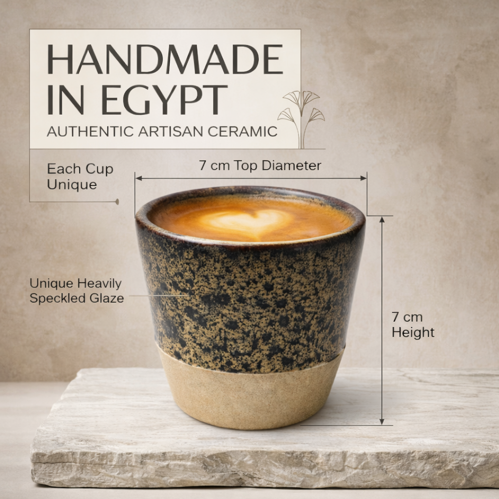 Ceramic cup with speckled glaze, labeled 'Handmade in Egypt', on a neutral background.