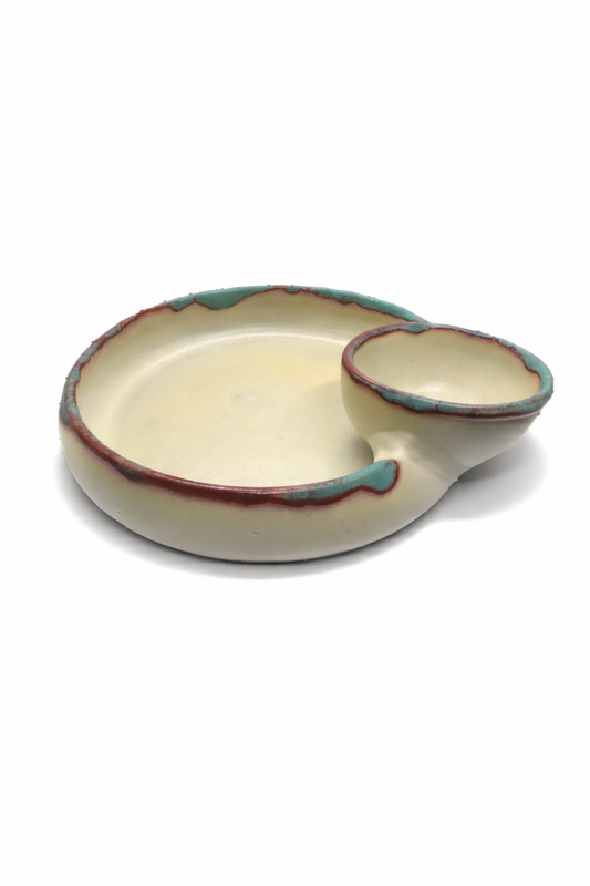 Ceramic dish with a handle on a white background