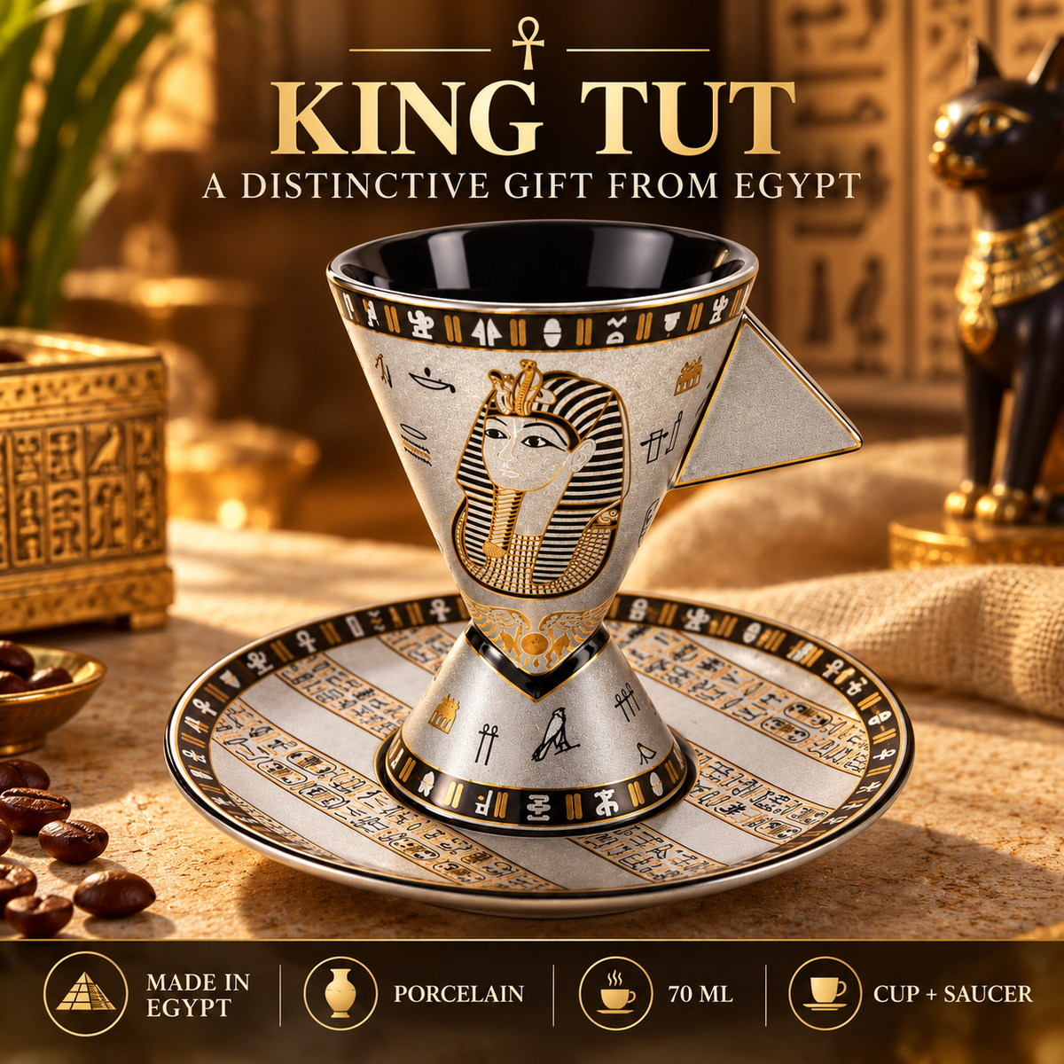 Egyptian-themed ceramic coffee cup and saucer set with a pharaoh design and hieroglyphic patterns, shown on a styled tabletop with coffee beans and decorative props. Text at the top reads 'KING TUT A DISTINCTIVE GIFT FROM EGYPT' and feature icons at the bottom mention made in Egypt, porcelain, 70 ml, and cup + saucer.