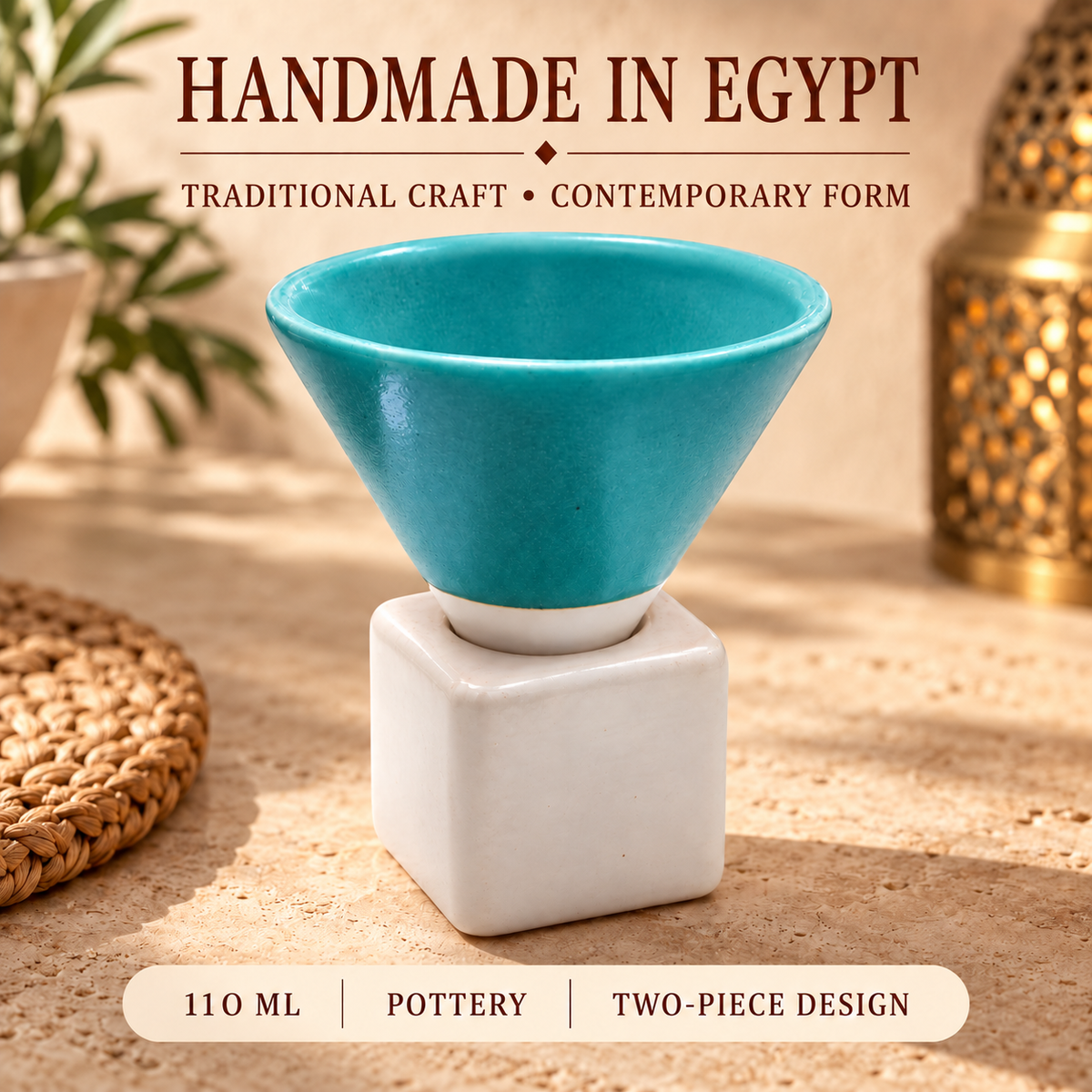 A two-piece ceramic cup featuring a glossy turquoise blue conical pot resting on a matte white square base, displayed on a sandy surface with decorative props and text overlays.