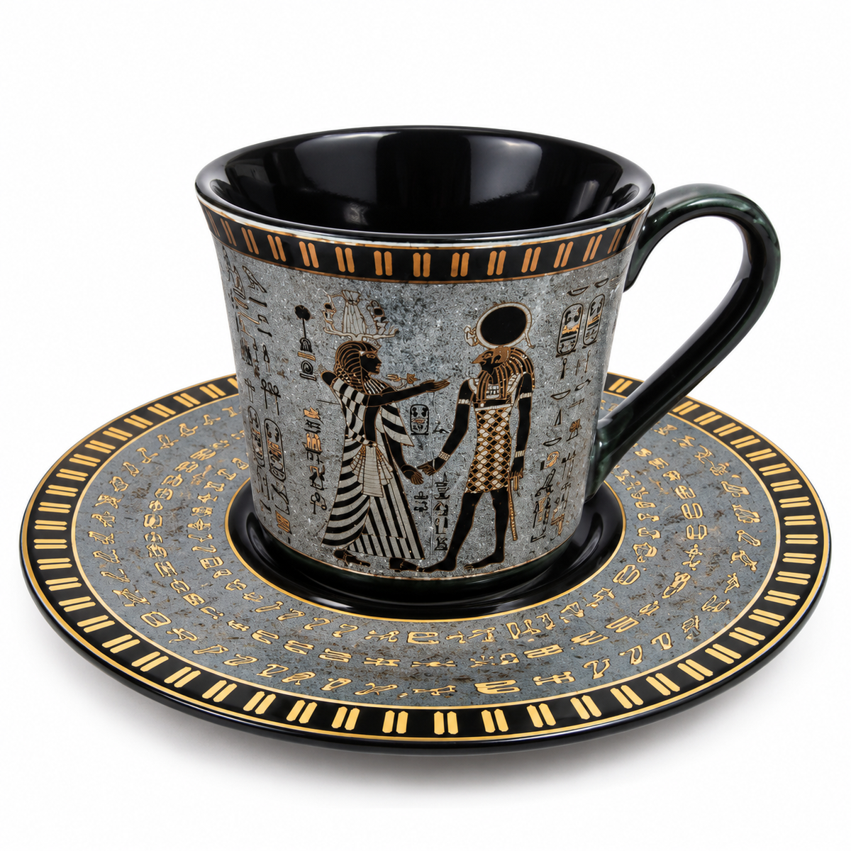 An Egyptian-themed ceramic coffee cup and saucer set. The cup features a black interior and handle, with a gray exterior decorated with gold hieroglyphs and figures.