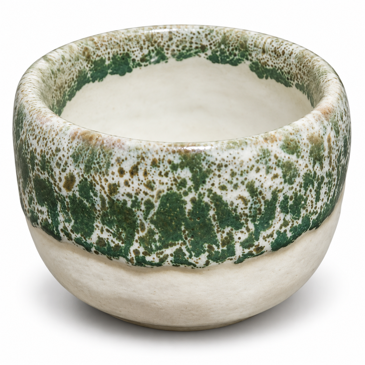 A handmade ceramic bowl with a textured, speckled green and beige glaze on the upper half and a smooth, matte cream-colored lower half, shown on a white background.