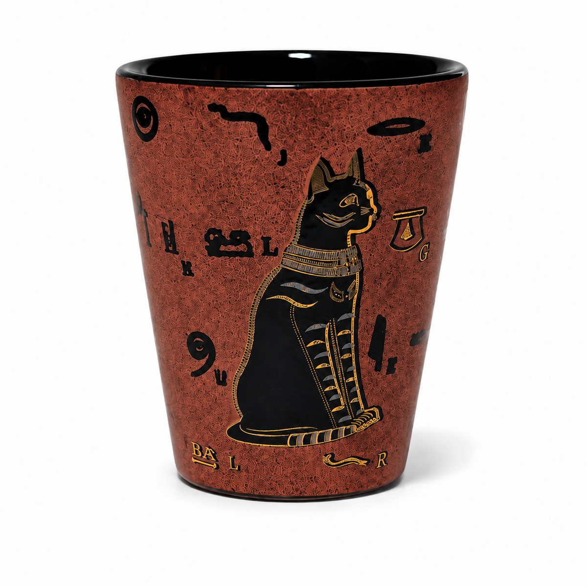 A tapered shot glass featuring an ancient Egyptian design with a black cat outlined in gold, surrounded by black hieroglyphic symbols on a textured reddish-brown speckled background, set against a plain white background.
