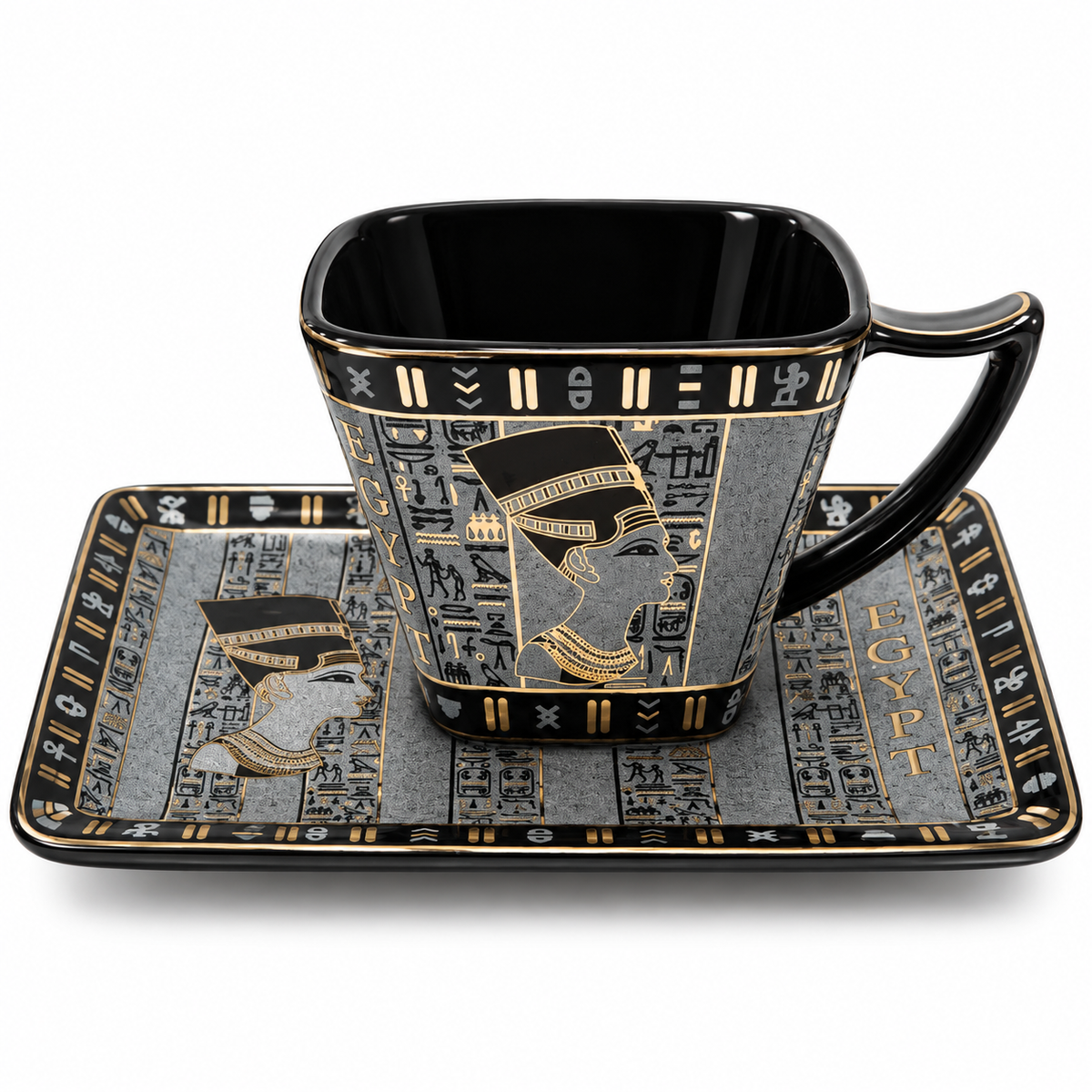 Egyptian-themed ceramic cup and saucer set with black and gold hieroglyphic designs, featuring a profile portrait of a pharaoh on the cup and a detailed hieroglyphic pattern on the saucer.