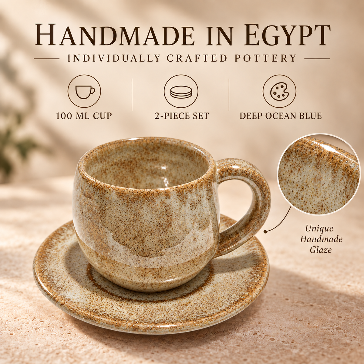 A handmade ceramic cup and saucer set in a warm speckled beige and brown glaze, with promotional text reading 'Handmade in Egypt' and a circular close-up of the unique hand-painted glaze.