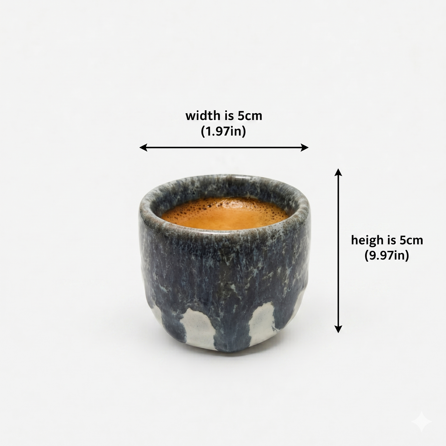 Small ceramic cup with coffee measurement on a white background