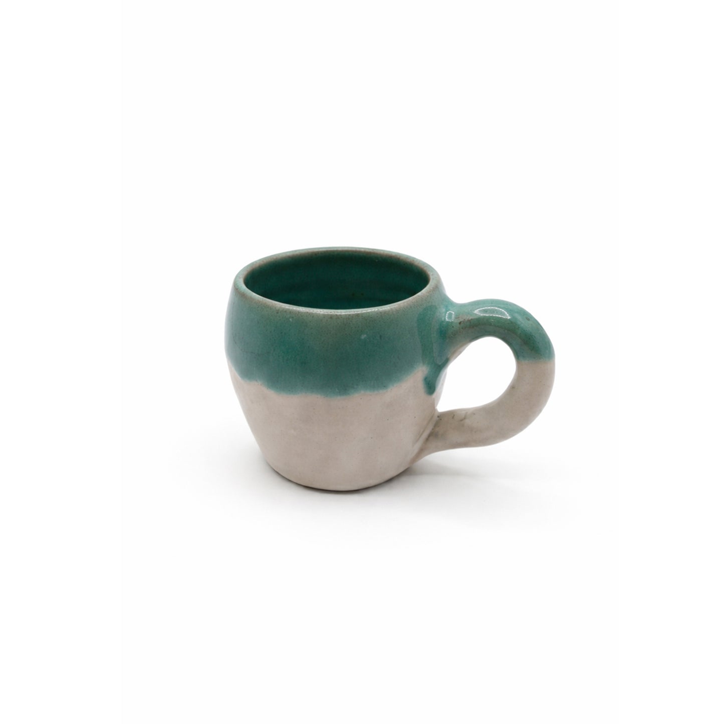Ceramic mug with green top and beige bottom on a white background
