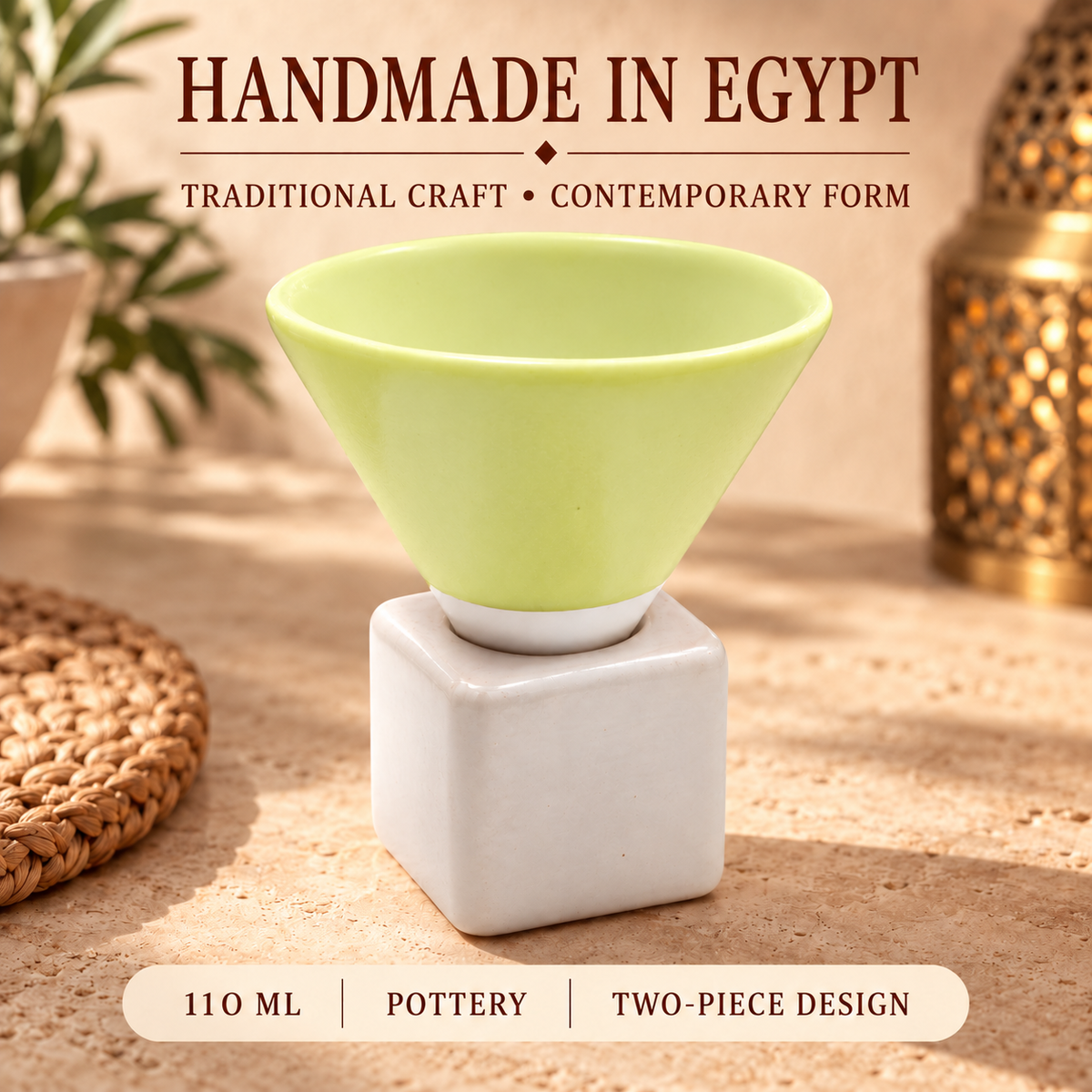 A two-piece ceramic cup set featuring a light green conical bowl and a white square base, displayed on a textured beige surface with decorative props and text overlays.