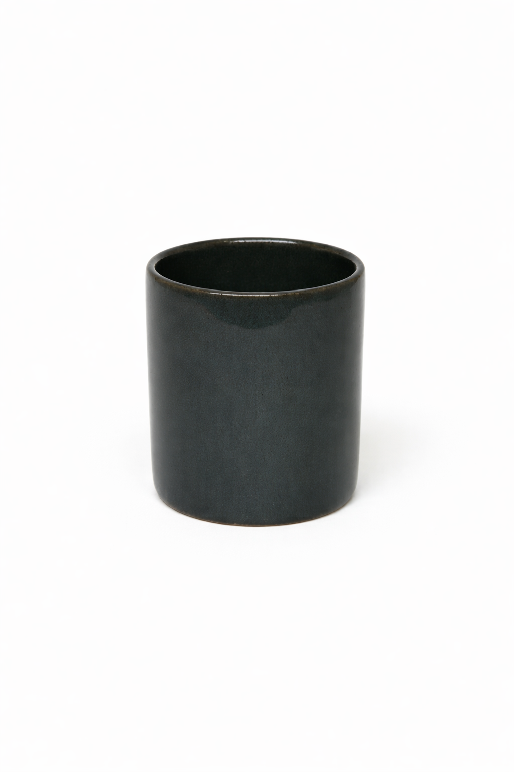 Petrol blue ceramic cup on a white background