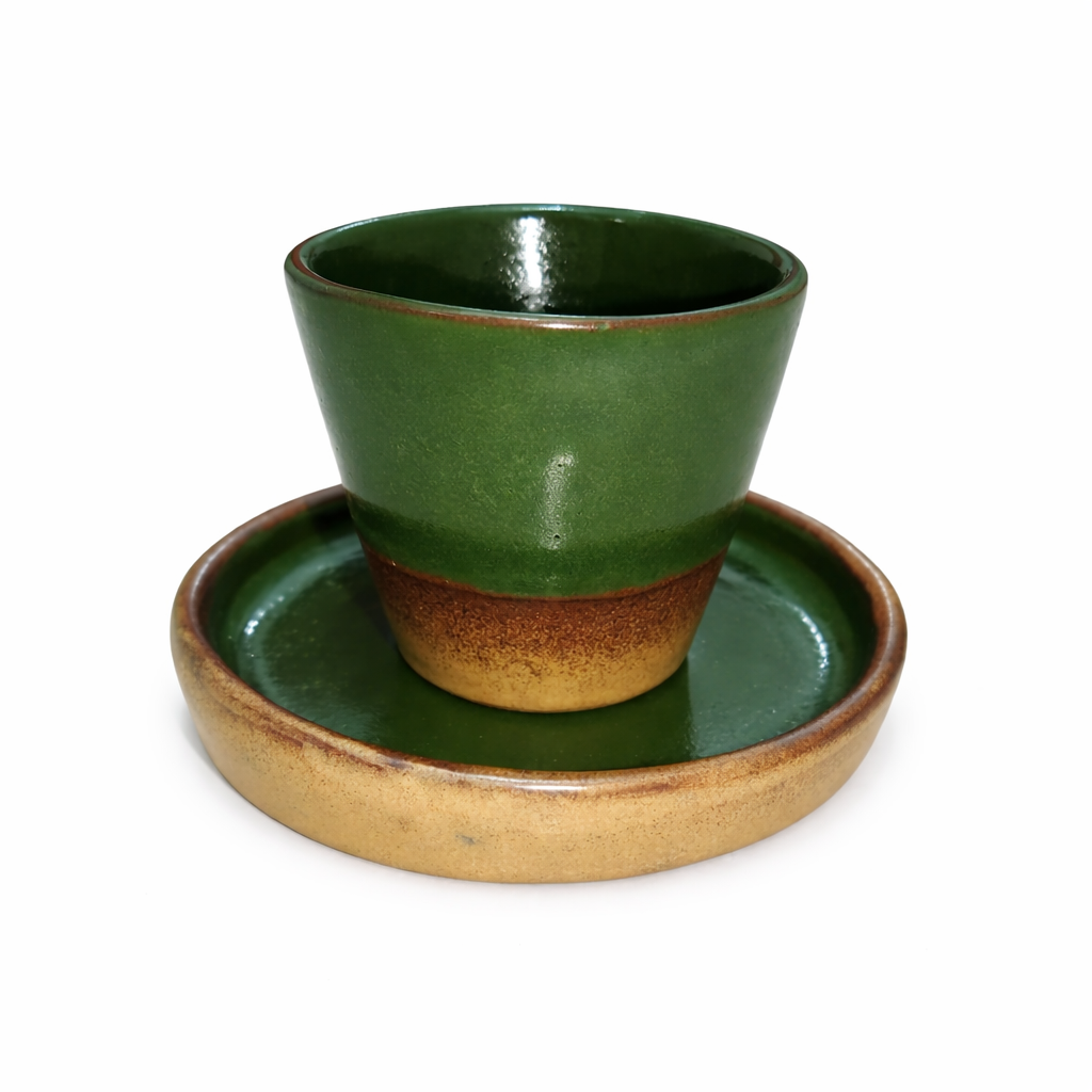 Green ceramic cup and saucer set on a white background