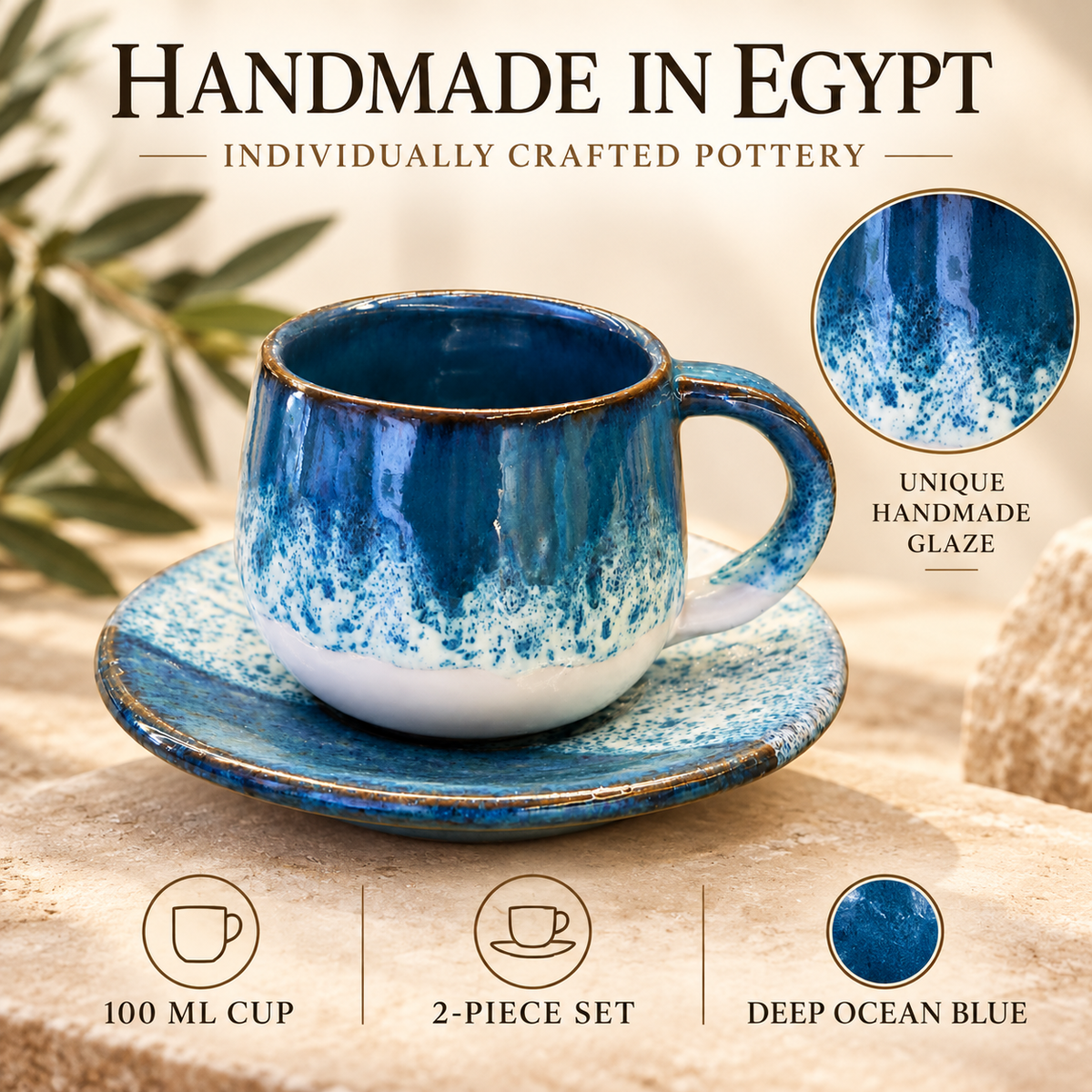 A handmade ceramic cup and saucer set in deep ocean blue with white glaze accents, displayed on a stone surface with decorative leaves in the background. Text overlays highlight the individual craftsmanship, unique handmade glaze, 100 ml cup size, 2-piece set, and deep ocean blue color.