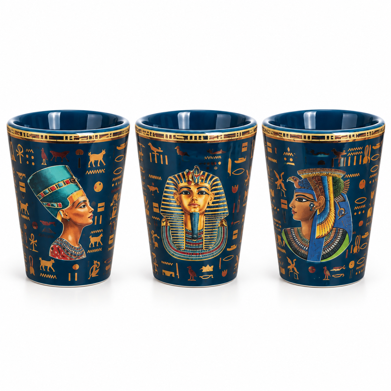 Three dark blue ceramic shot glasses with gold Egyptian hieroglyphics and colorful pharaoh illustrations, shown on a white background.
