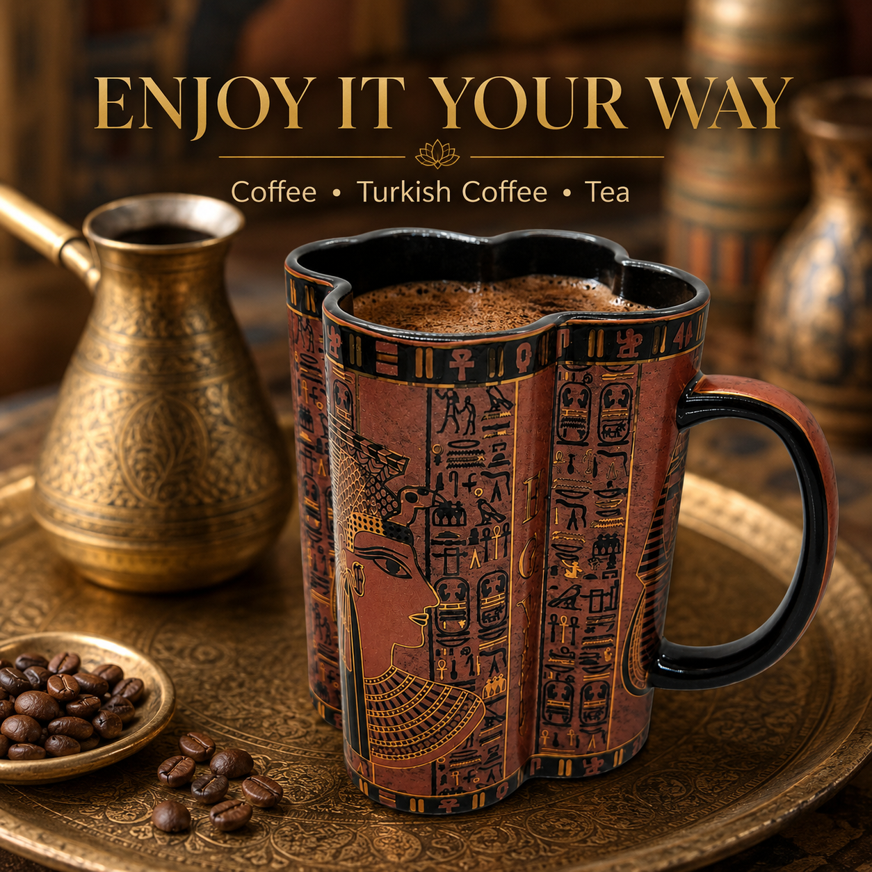 An ornate ceramic mug with an Egyptian hieroglyphic design, filled with coffee and set on a gold-toned tray alongside a Turkish coffee pot, coffee beans, and the text 'ENJOY IT YOUR WAY'.