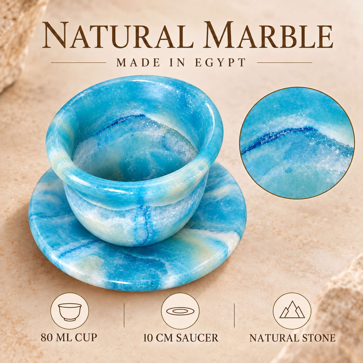 Blue and white marbled natural stone cup and saucer set on a beige textured background, with text reading 'NATURAL MARBLE MADE IN EGYPT' and feature icons below.