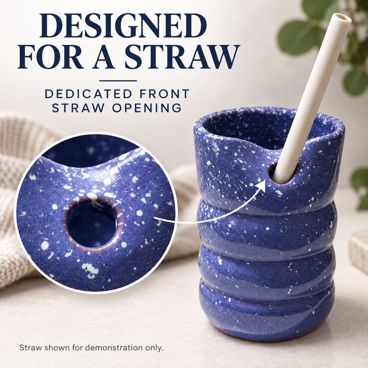 A blue speckled ceramic cup with a front straw opening, shown with a white straw inserted. Large text reads 'DESIGNED FOR A STRAW' and 'DEDICATED FRONT STRAW OPENING,' with a circular inset highlighting the opening and a note saying the straw is shown for demonstration only.