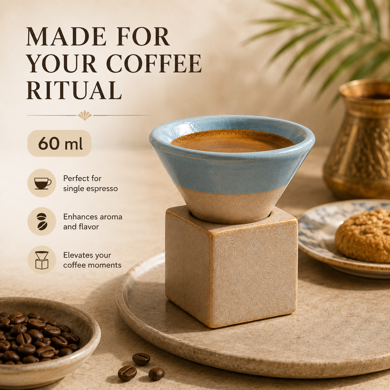 A ceramic coffee cup with a light blue top and beige base sits on a square beige block, styled on a tray with coffee beans, a cookie, and a small pot in a warm, rustic setting. Text on the left reads 'MADE FOR YOUR COFFEE RITUAL' with feature callouts including 60 ml.
