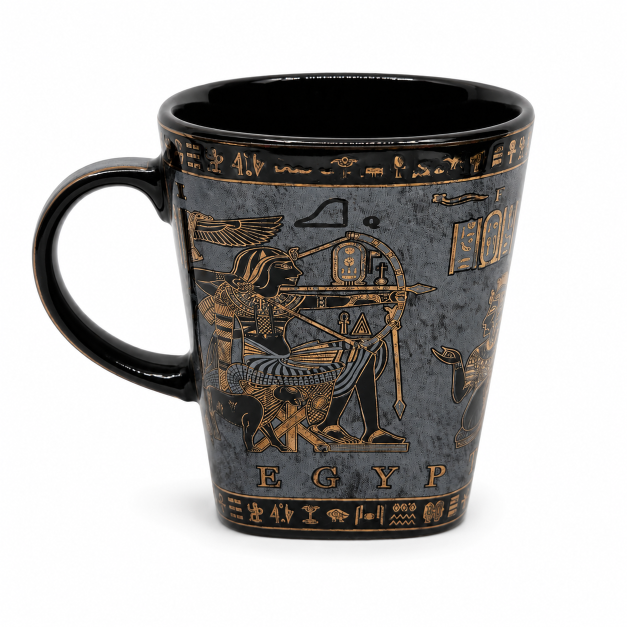 A black ceramic coffee mug featuring gold-colored Egyptian hieroglyphs and illustrations, including the goddess Isis and the word 'EGYP'.