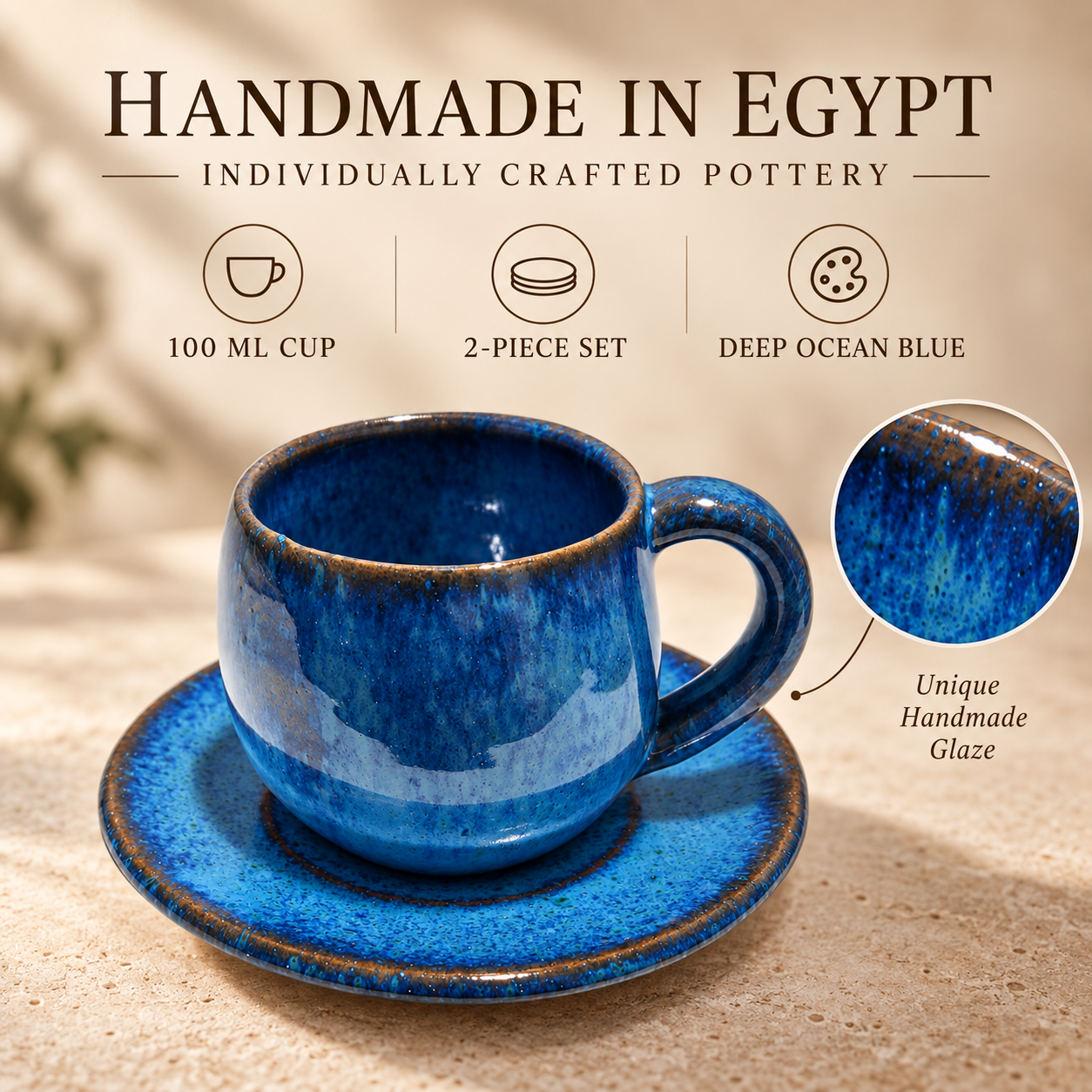 A blue handmade ceramic cup and saucer set with a glossy deep ocean blue glaze and brown speckled edges, shown on a beige textured surface. The image includes marketing text reading 'HANDMADE IN EGYPT' and icons describing the cup size, 2-piece set, and deep ocean blue color, plus a circular close-up of the glaze texture.