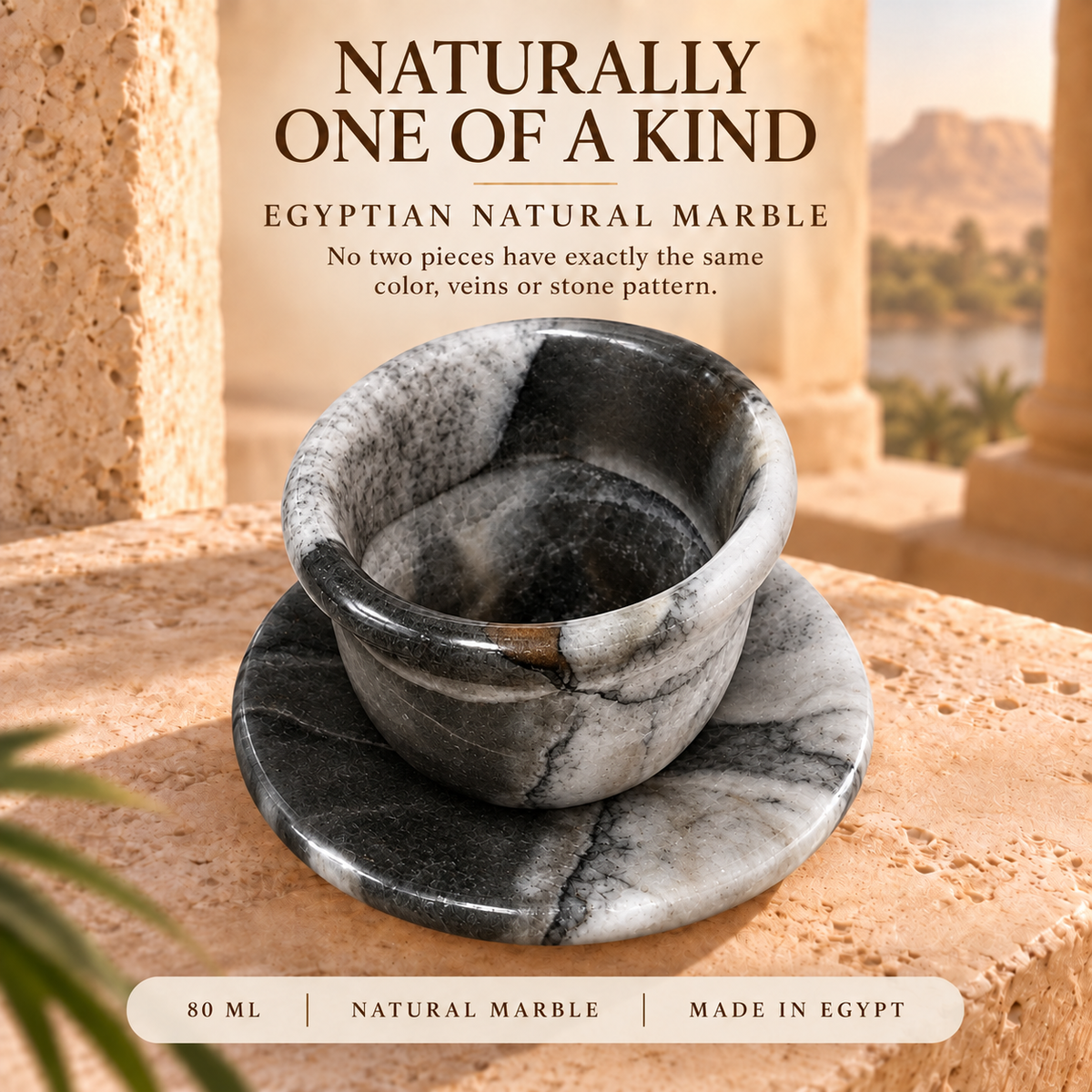 A small Egyptian natural marble cup and saucer set displayed on a stone surface with a warm outdoor background. Text at the top reads 'NATURALLY ONE OF A KIND' and 'EGYPTIAN NATURAL MARBLE,' with a bottom banner noting 80 ML, NATURAL MARBLE, and MADE IN EGYPT.