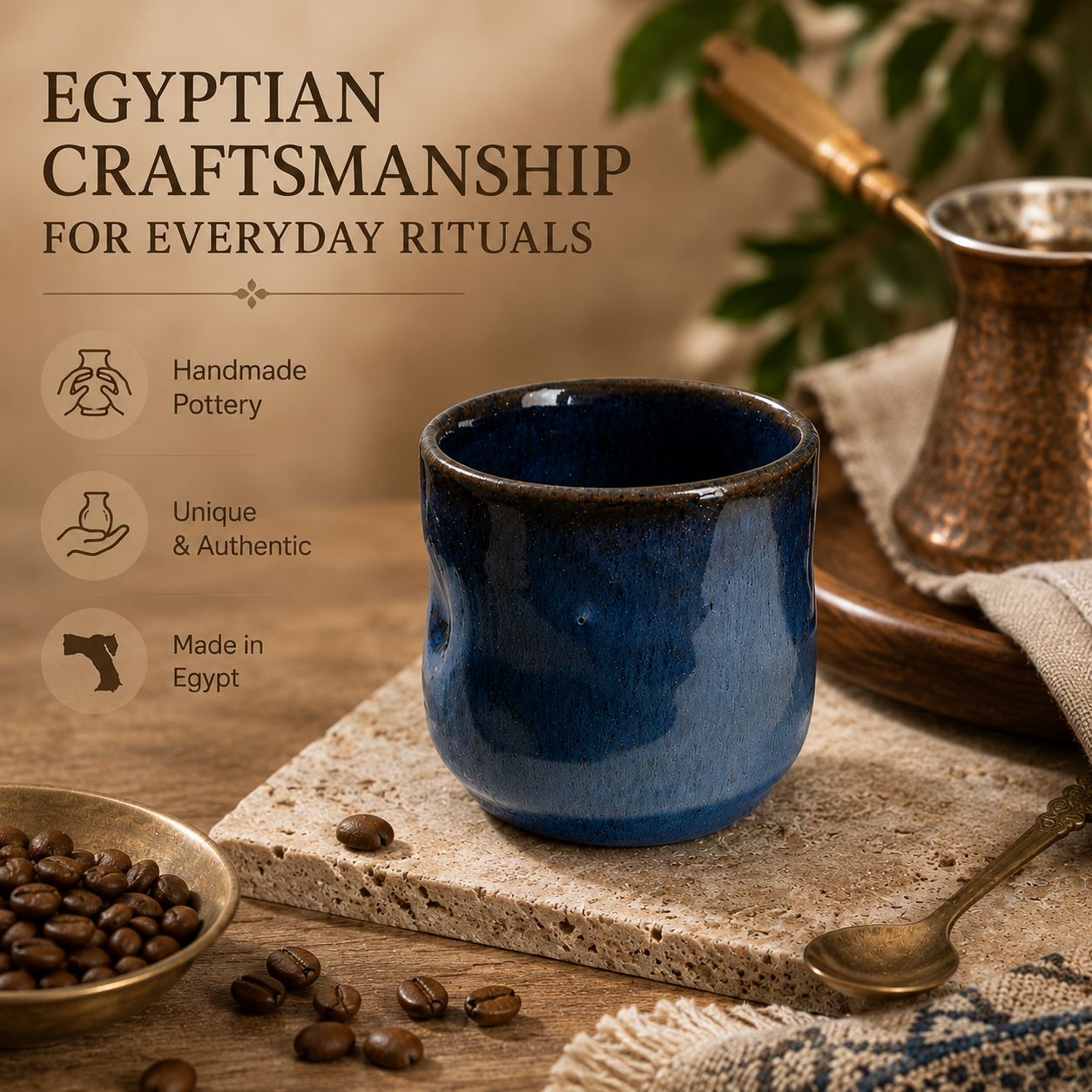A dark blue glazed ceramic cup with a wavy rim, styled on a stone slab with coffee beans, a copper pot, and a spoon in a warm, rustic setting. Text on the left reads 'EGYPTIAN CRAFTSMANSHIP FOR EVERYDAY RITUALS' with icons for handmade pottery, authentic uniqueness, and Made in Egypt.