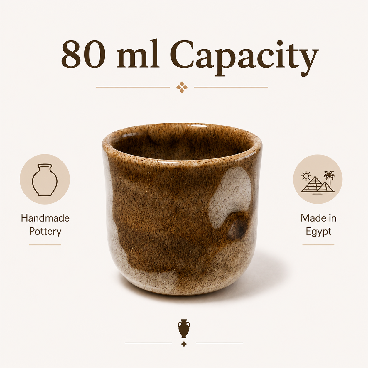 A small handmade ceramic cup with a brown and beige glaze, centered on a light beige background with text reading '80 ml Capacity' and callouts for 'Handmade Pottery' and 'Made in Egypt'.