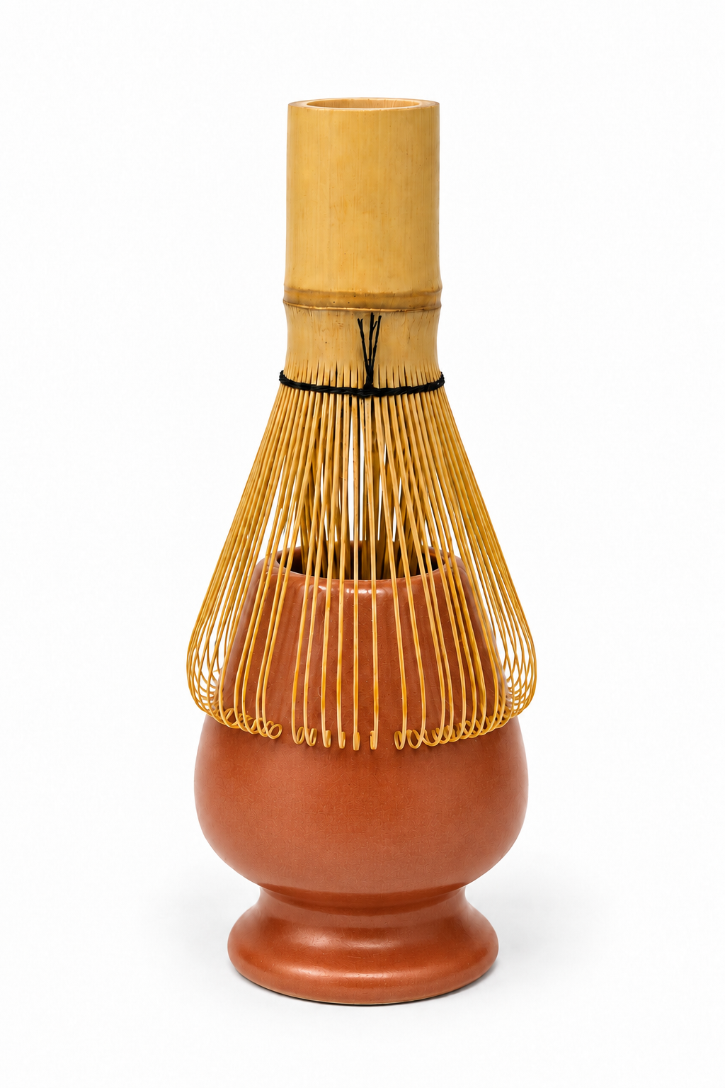 A traditional Japanese bamboo whisk (chashaku) with a light natural bamboo top, a black cord accent, and fine golden-yellow bristles surrounding a terracotta-colored lower body, set against a plain white background.